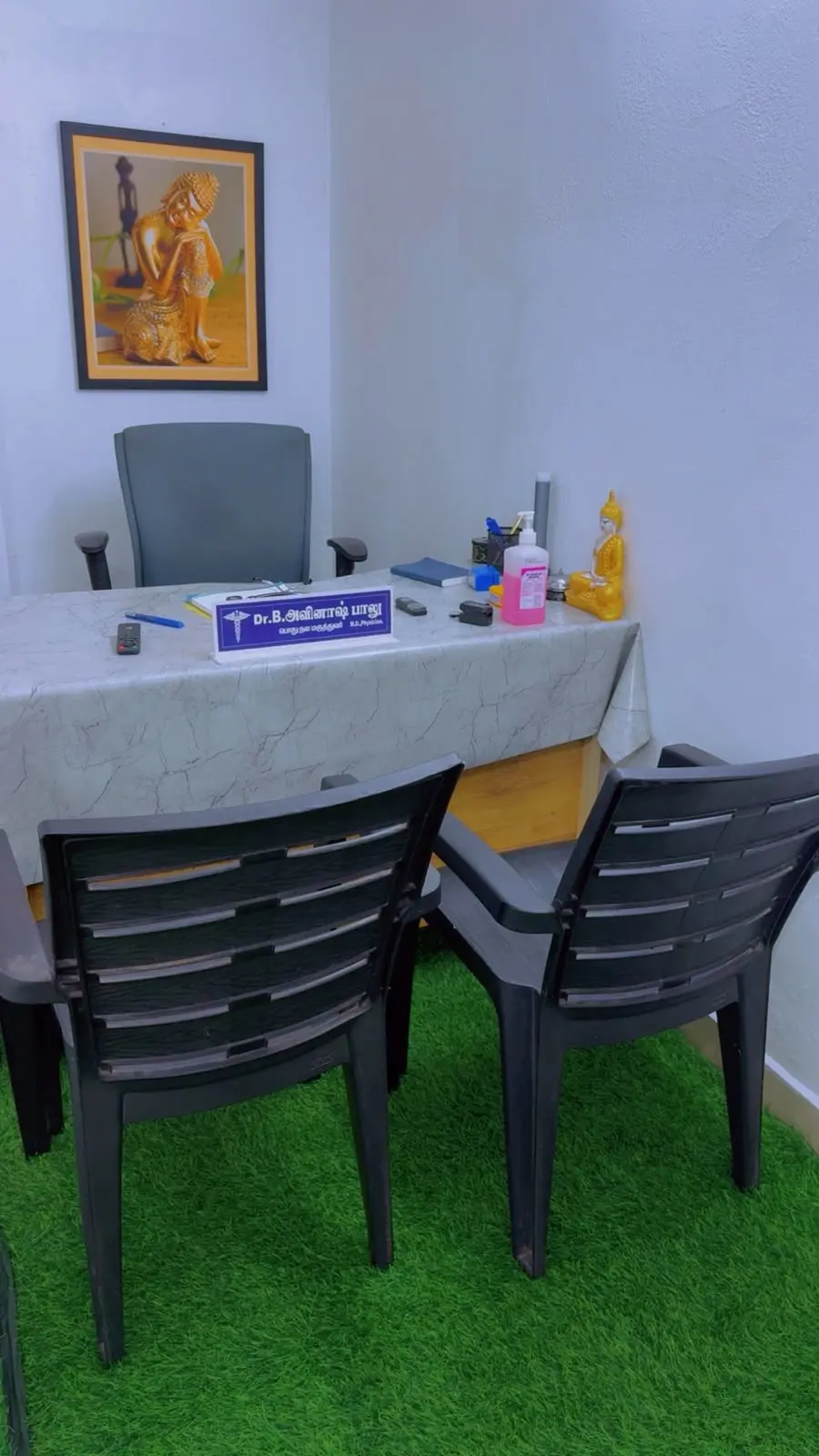 The doctor's desk with his nameplate and two chairs for patients